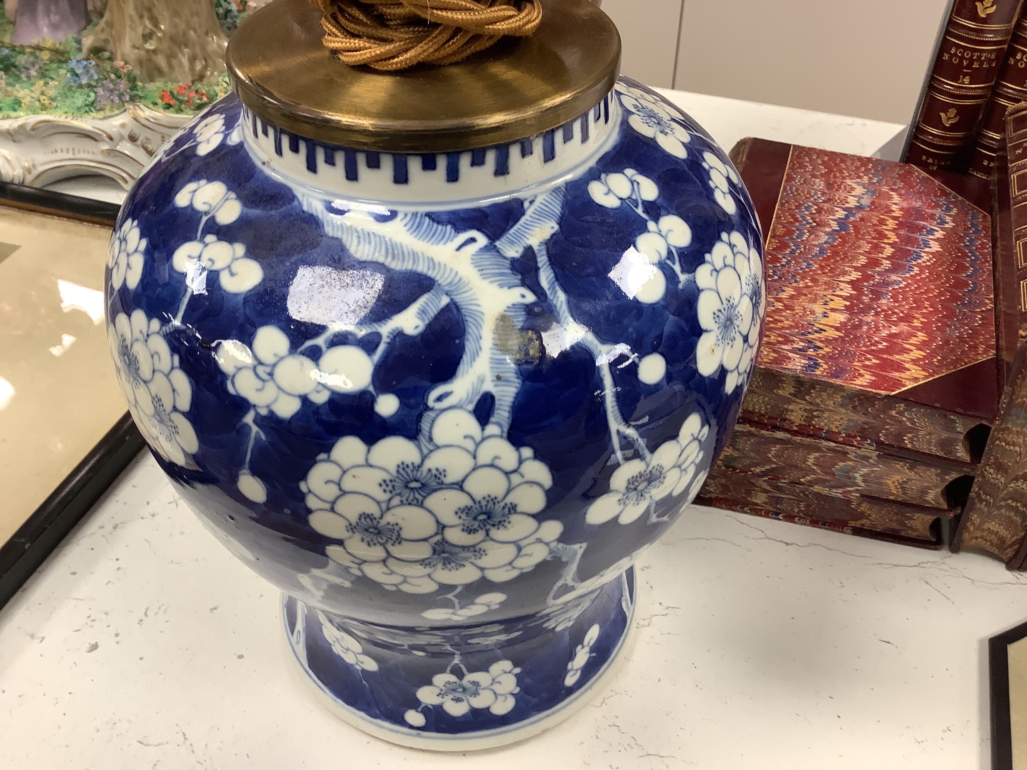 A large Chinese sang de boeuf lamp base and a similar blue and white prunus lamp base, both Qing dynasty, 41 and 21 cm high excluding fittings